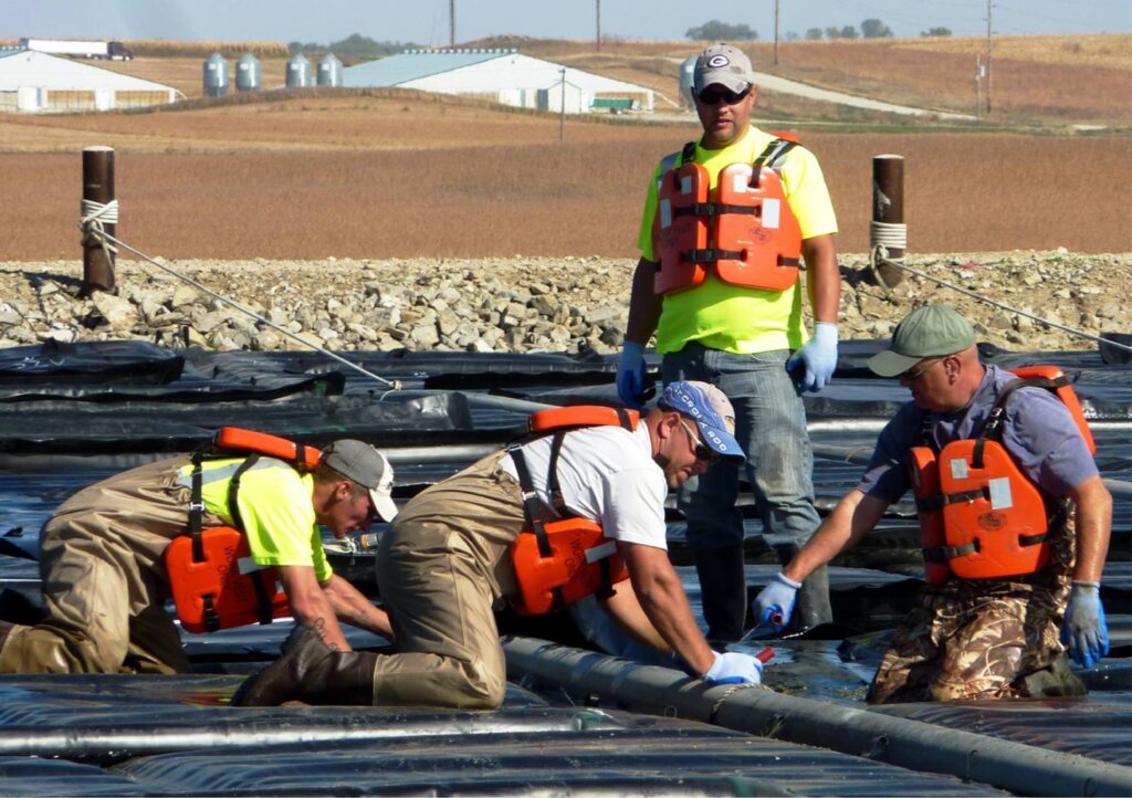 Workers at a water treatment facility outdoors