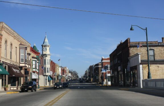 Photograph of main street of Berlin, Wisconsin with clock tower turret and various brick buildings